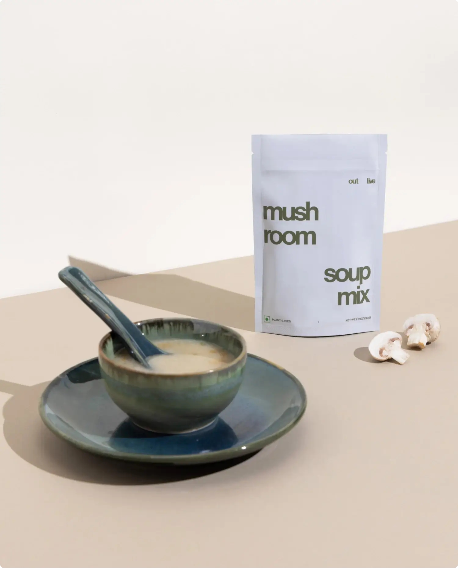 Outlive Mushroom Soup Mix served in a ceramic bowl with a spoon, showcasing its creamy texture. A nutritious meal replacement to support immunity.